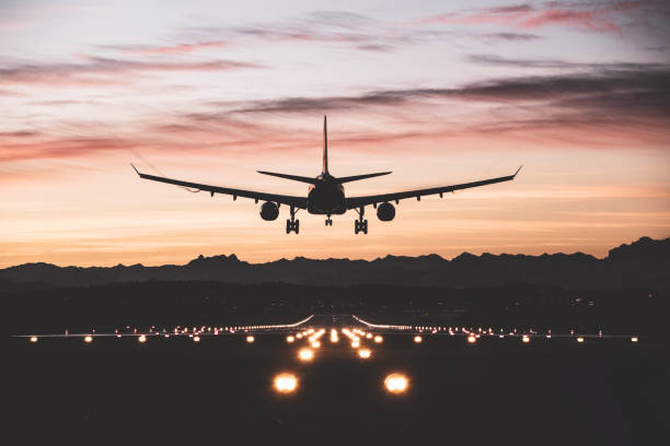 Home an airplane moments from touching down on the runway at sunrise.