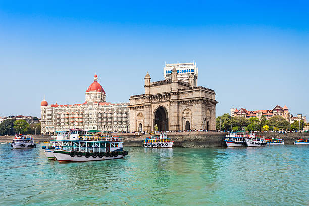 Home the gateway of india and boats as seen from the mumbai harbour in mumbai, india